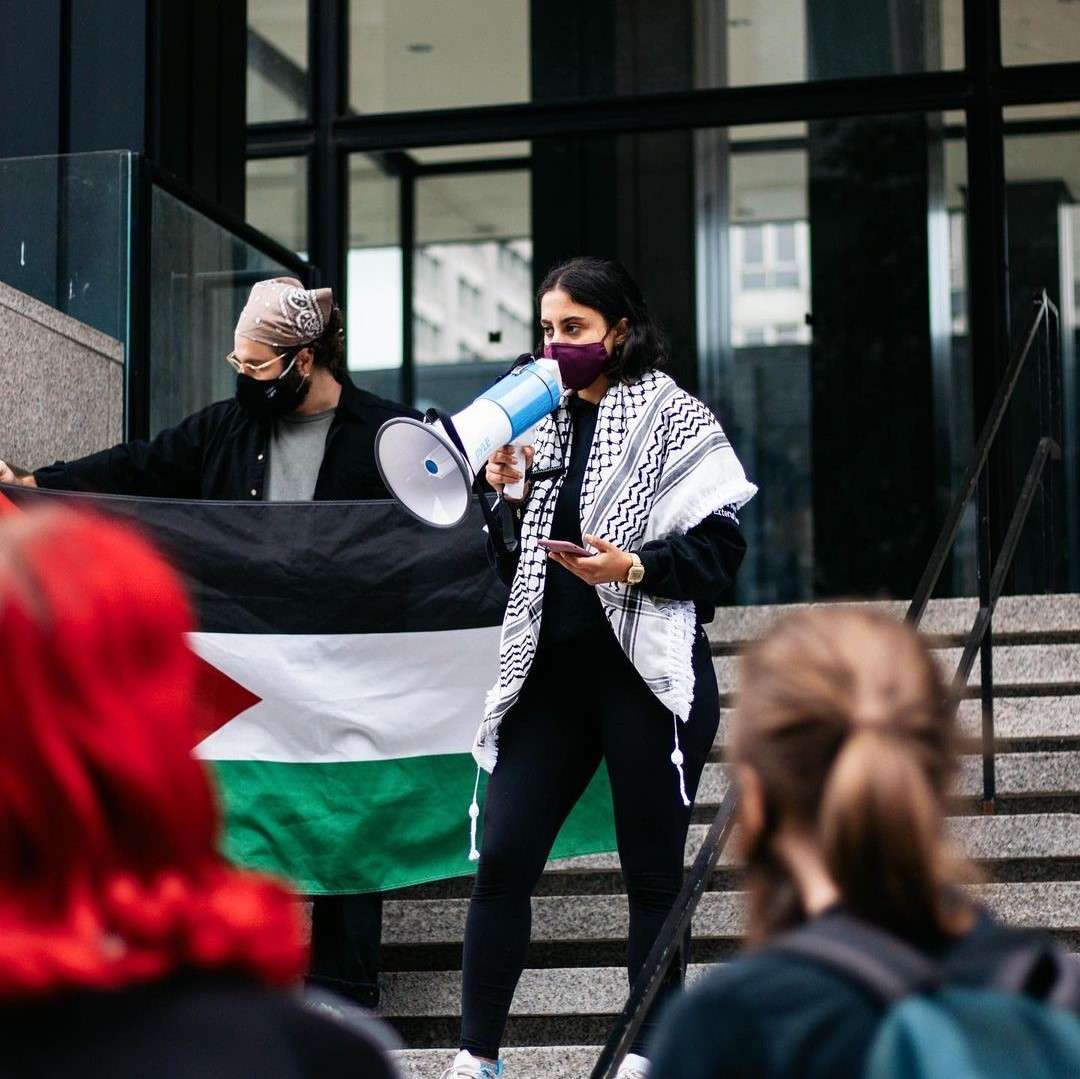 Lady with Speaker Wearing a Kufiya